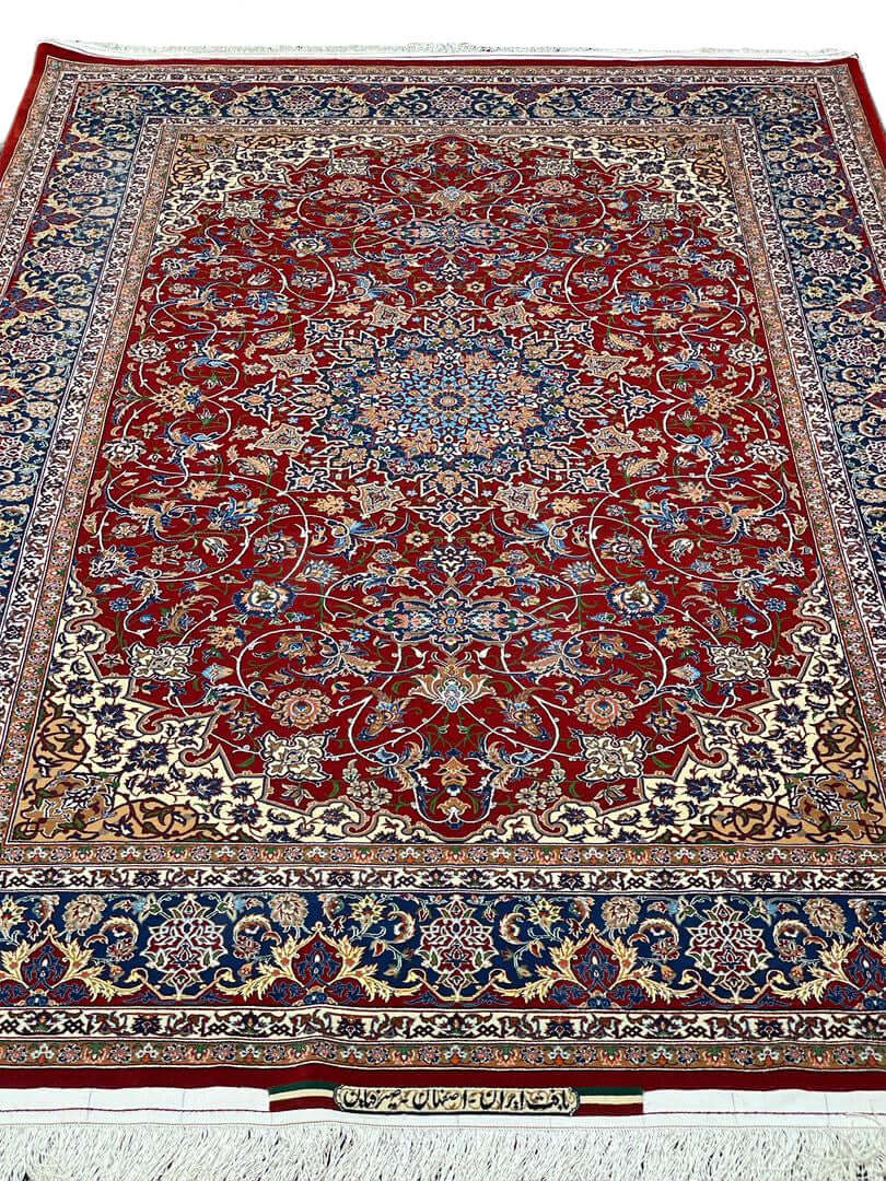 "Handwoven Isfahan rug by Master Bagher Seirafian with red, navy, and cream tones."